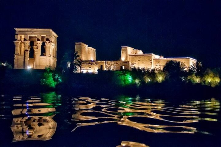 Illuminated Philae Temple reflected on the Nile at night in Aswan