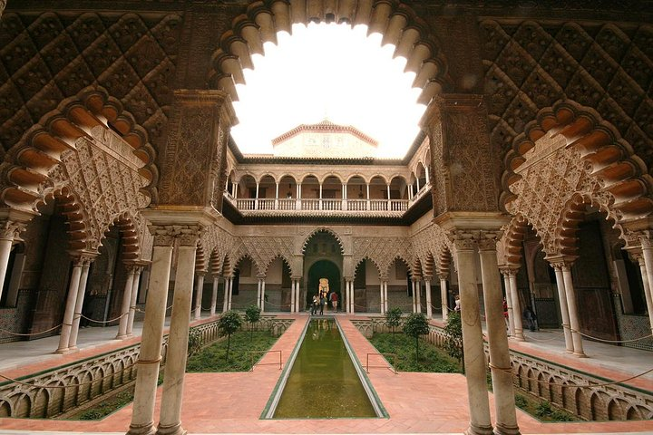Explore the stunning gardens and intricate architecture of Alcazar de Sevilla immersing yourself in history while enjoying a personalized tour at your own pace. Discover the charm of these royal palaces.