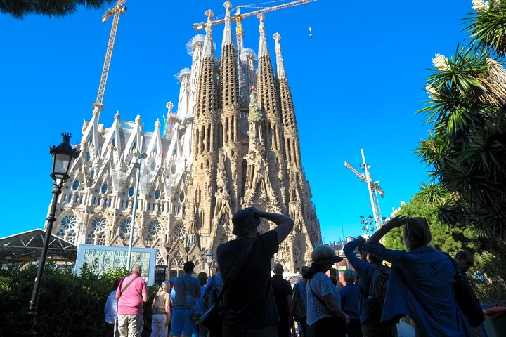 Discover the stunning architecture of La Sagrada Familia as you join fellow travelers marveling at its intricate details while enjoying priority access to this world-renowned masterpiece in Barcelona.