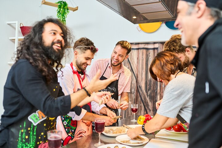 Experience the joy of cooking as you engage with fellow food lovers learning to create authentic paella from the freshest ingredients in a lively and interactive cooking class.