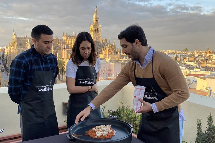 Experience culinary magic while mastering paella with stunning views of Seville's Cathedral. Enjoy hands-on instruction and learn to create unforgettable meals with expert guidance.