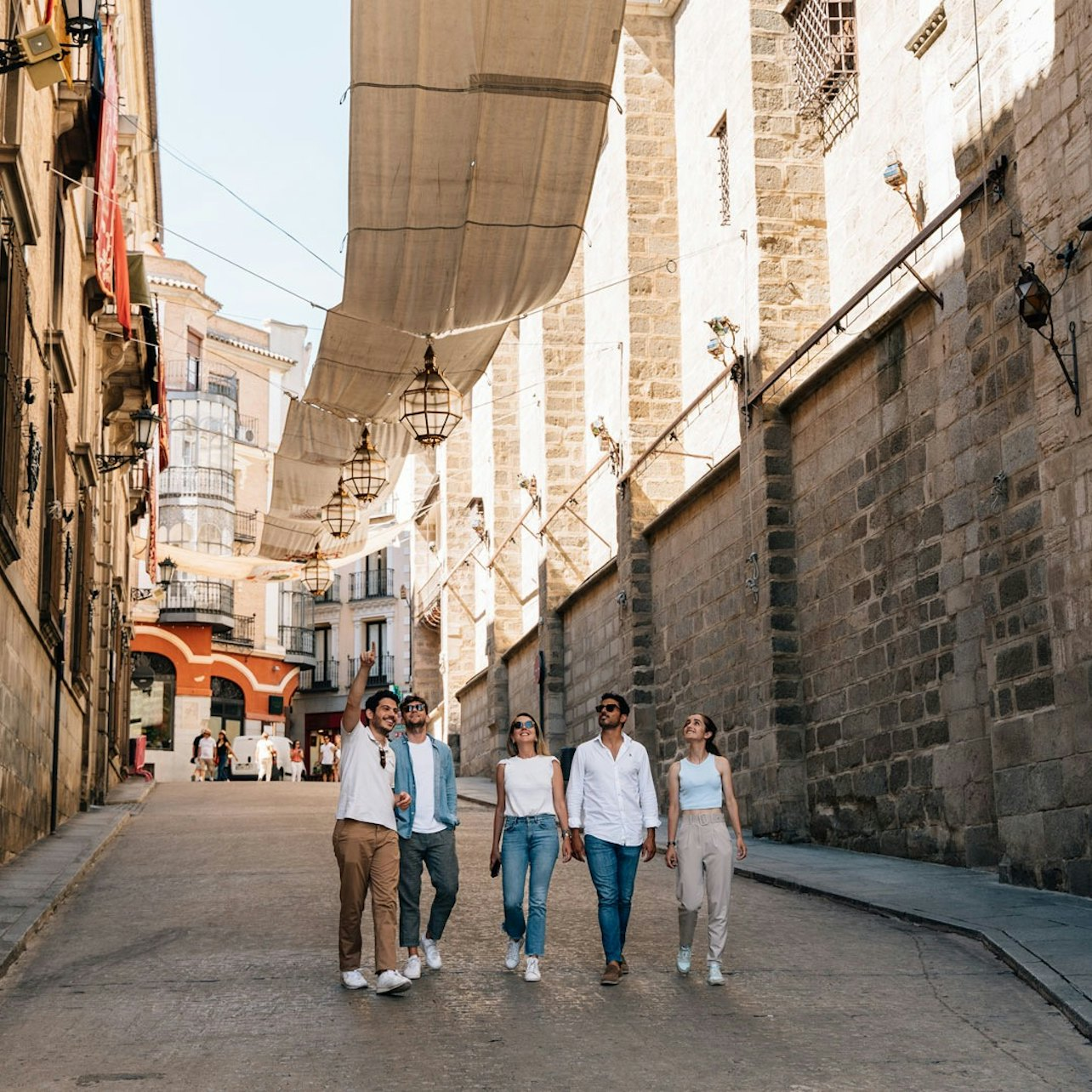 Wander through the charming streets embracing a rich blend of history and culture among ancient architecture while capturing unforgettable moments with friends in Spain's iconic cities.