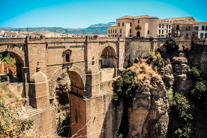 Explore the stunning architectural marvel of Ronda’s famous bridge perched high above a dramatic gorge offering breathtaking views and a glimpse into the town's rich history and culture.