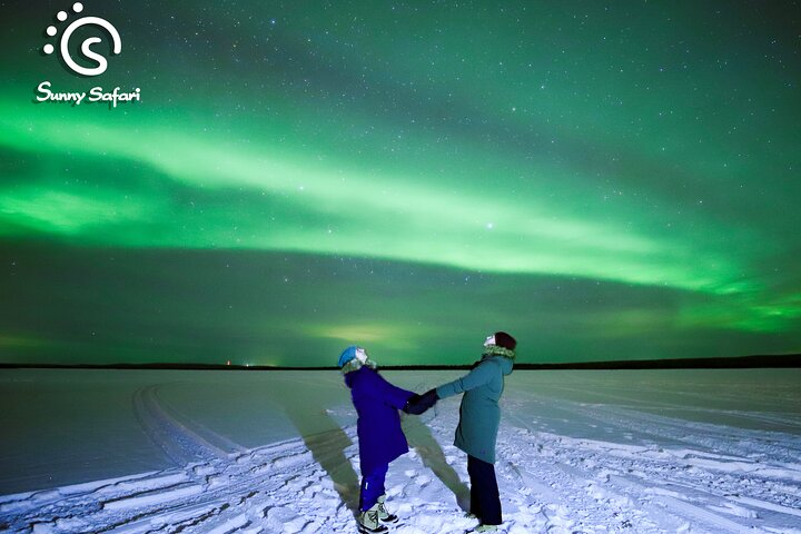 Experience the mesmerizing dance of the Northern Lights as you capture unforgettable moments under the vast Arctic sky sharing stories and warmth around a cozy campfire.