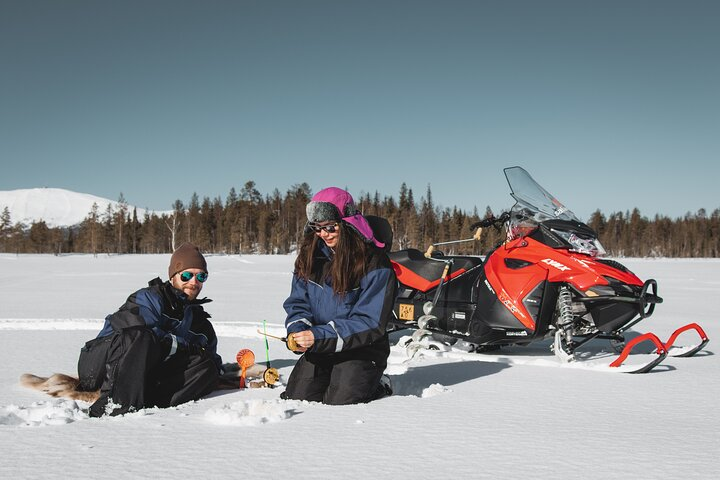 Experience the serene beauty of Lapland while snowmobiling across pristine snowfields and ice fishing in a breathtaking landscape. Enjoy a hearty meal as you soak in the stunning views.