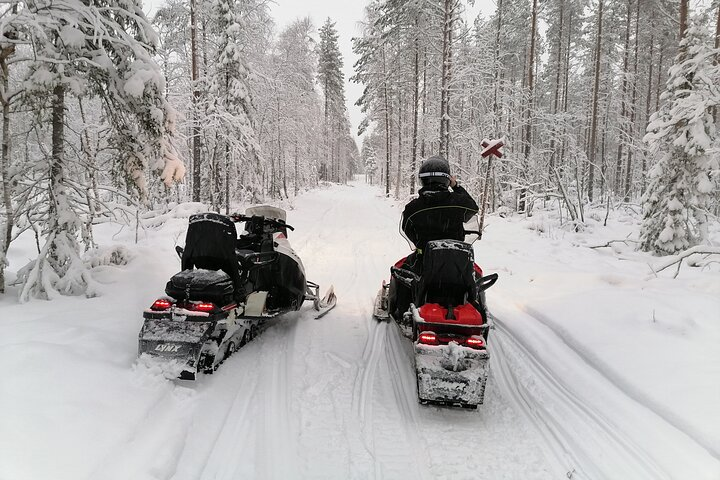 Explore the serene beauty of Rovaniemi's snowy forests on a private snowmobile adventure guided through breathtaking landscapes and surrounded by the tranquility of Lapland's winter wonderland.