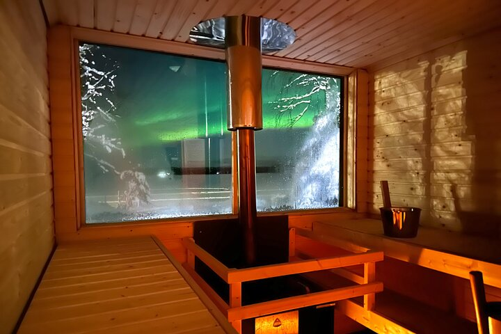 Experience the serenity of a wooden sauna with stunning views of the Northern Lights where relaxation meets the beauty of Finnish nature and traditional wellness practices.