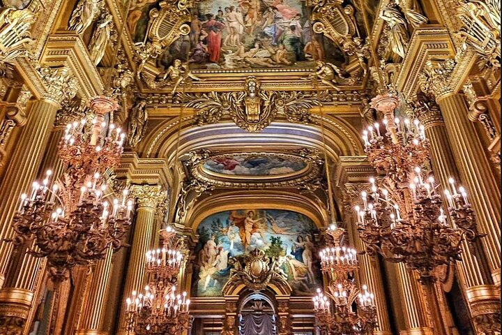 Step into a world of elegance at Opéra Garnier where opulent chandeliers and stunning artistic ceilings transport you to a grand era of Parisian culture and history.