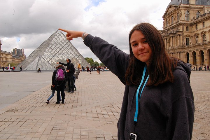 Touching the pyramid of the louvre. children love the optical illusion 