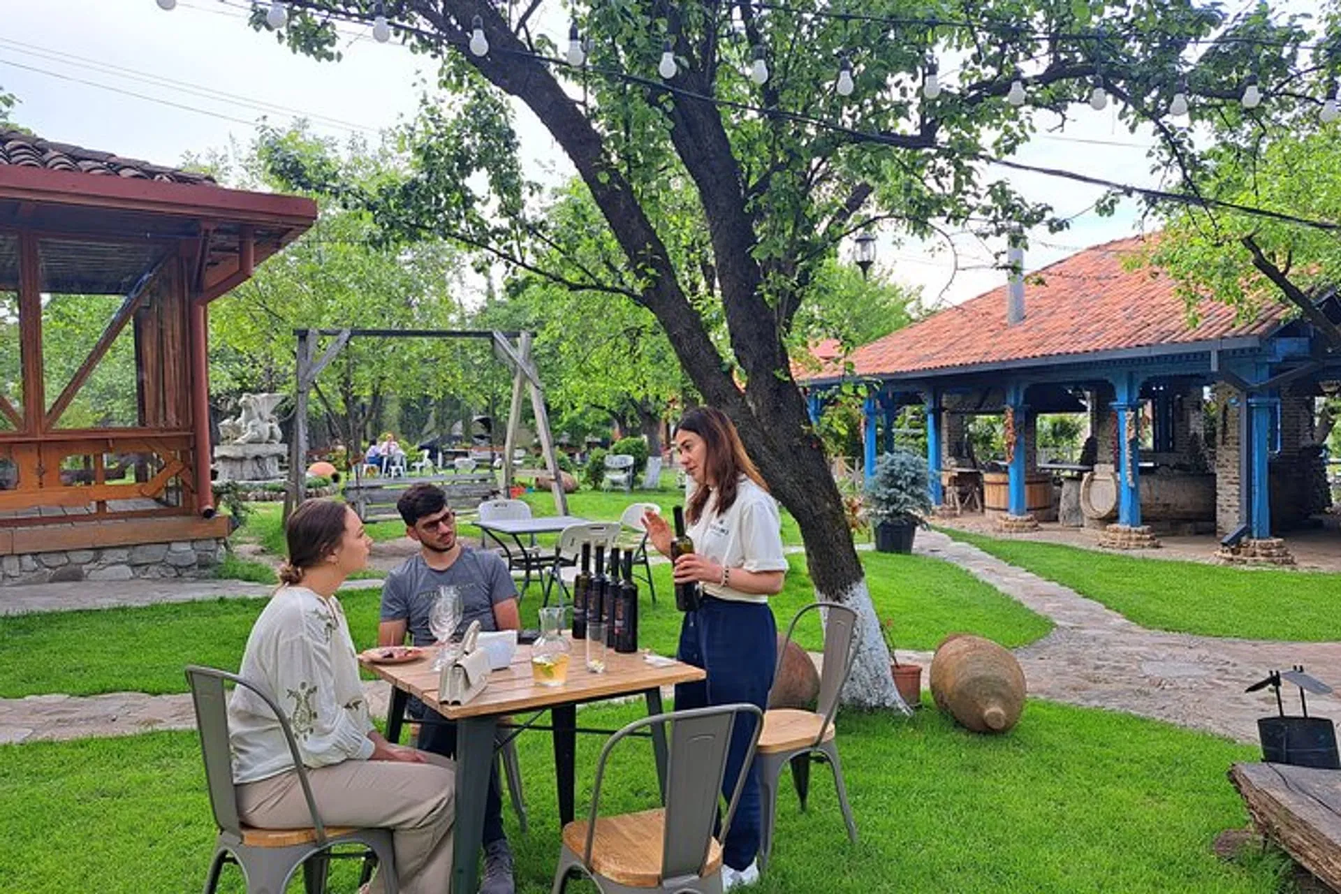 Guests enjoying an outdoor wine tasting at a Kakheti winery