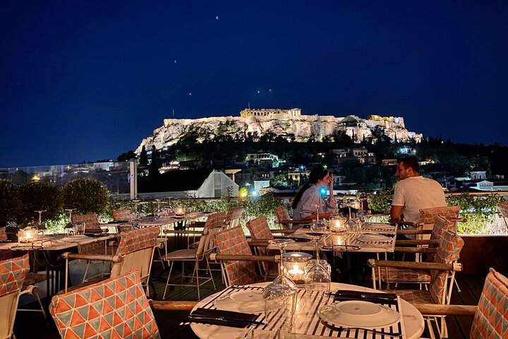 Savor local drinks at stylish roof bars with the stunning Parthenon illuminating the night creating the perfect backdrop for unforgettable moments in Athens.