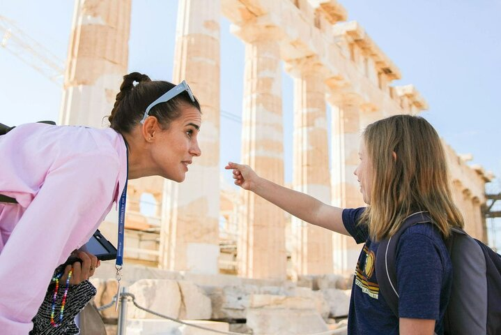 Family-friendly guide conversing with a kid on the Acropolis Hill