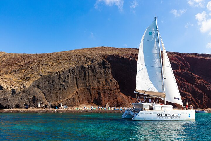 Marvel and take photos next to the Red Beach Cliff . Drop anchor at Santorini's best! Our top-of-the-line Lagoon catamaran will take you to Red Beach.