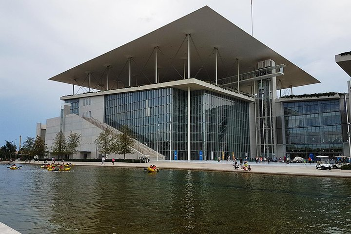 Discover the stunning architecture of the Stavros Niarchos Foundation Cultural Center surrounded by serene waters and landscaped gardens perfect for a leisurely stroll and relaxation.