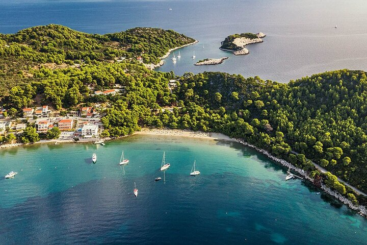 Saplunara bay, with sandy beaches waiting for you to hop in