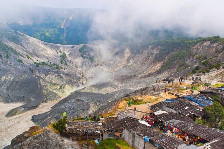Witness the stunning crater of Tangkuban Parahu Volcano surrounded by lush tea plantations and rice fields while soaking in the rich cultural backdrop of local farmers and fresh markets.