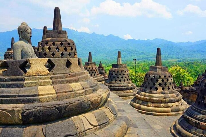 Explore the stunning architecture of Borobudur surrounded by lush landscapes. Discover ancient history and serene views making your journey truly unforgettable during your Adventure Trip across Java.