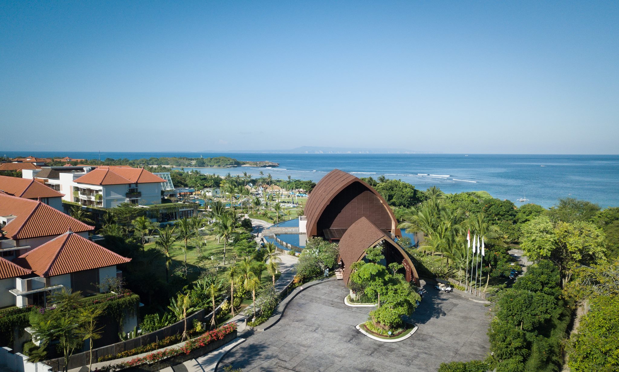 Savor a delightful afternoon tea at Gading Restaurant while enjoying stunning views of turquoise waters and lush landscapes blending diverse culinary experiences in the heart of Bali.