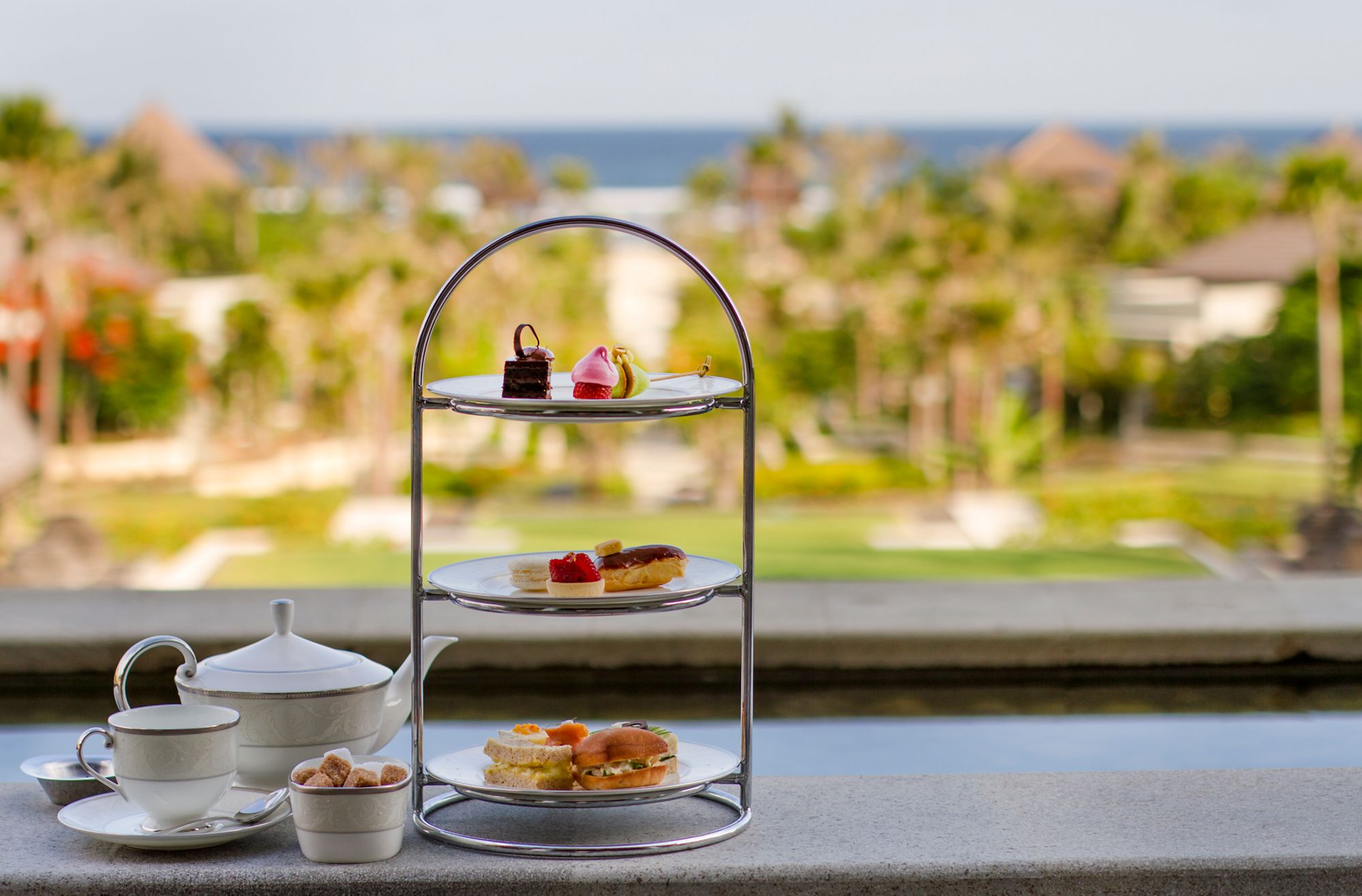 Savor delightful treats while enjoying breathtaking ocean views at The Ritz-Carlton Lounge & Bar where exquisite teas and fine pastries make every moment a memorable escape.