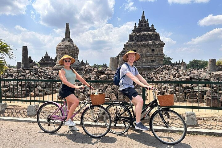 Discover ancient temples while cycling through Yogyakarta engaging with local culture and savoring traditional emping chips in a unique blend of history and nature.