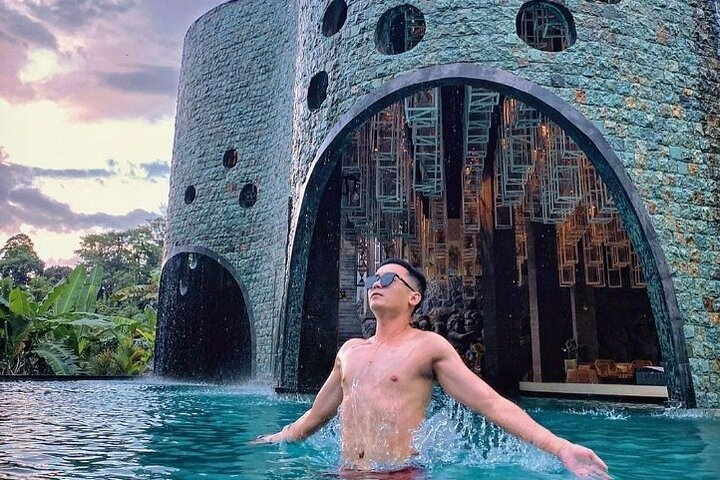 Experience the serenity of Bali from the stunning Tlaga Singha Infinity Pool where lush surroundings and breathtaking river views create an unforgettable escape for travelers.