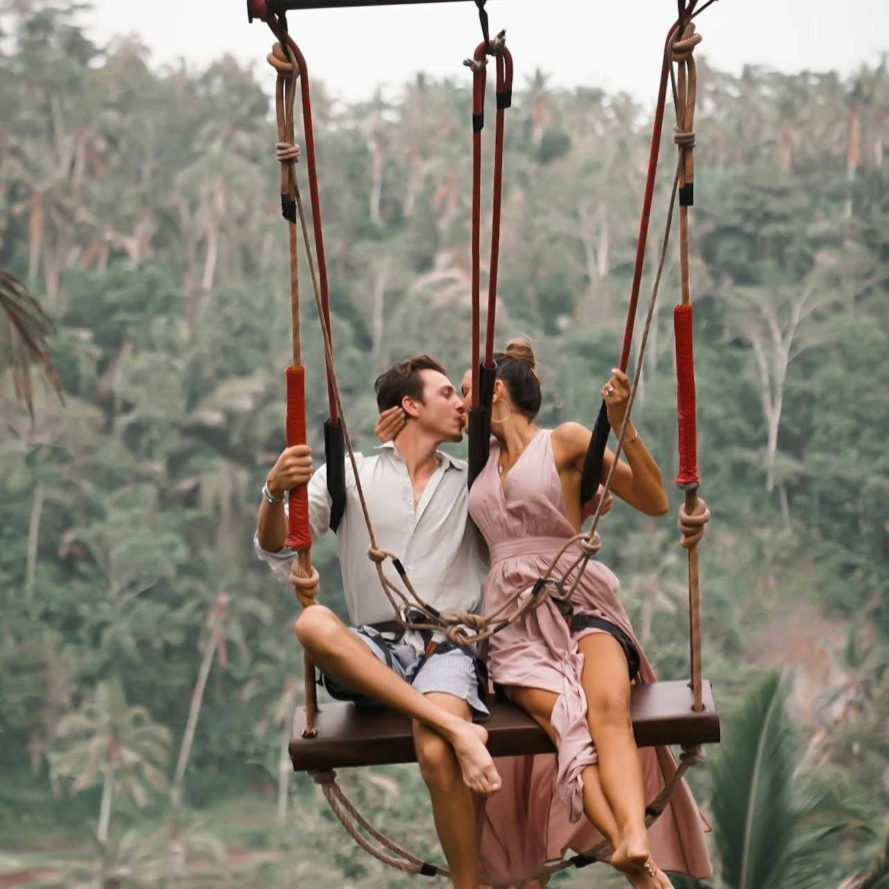 Experience the joy of swinging high above the lush Tegalalang Rice Terrace embracing Bali's natural beauty while creating unforgettable memories with loved ones. Adventure awaits in this serene paradise.