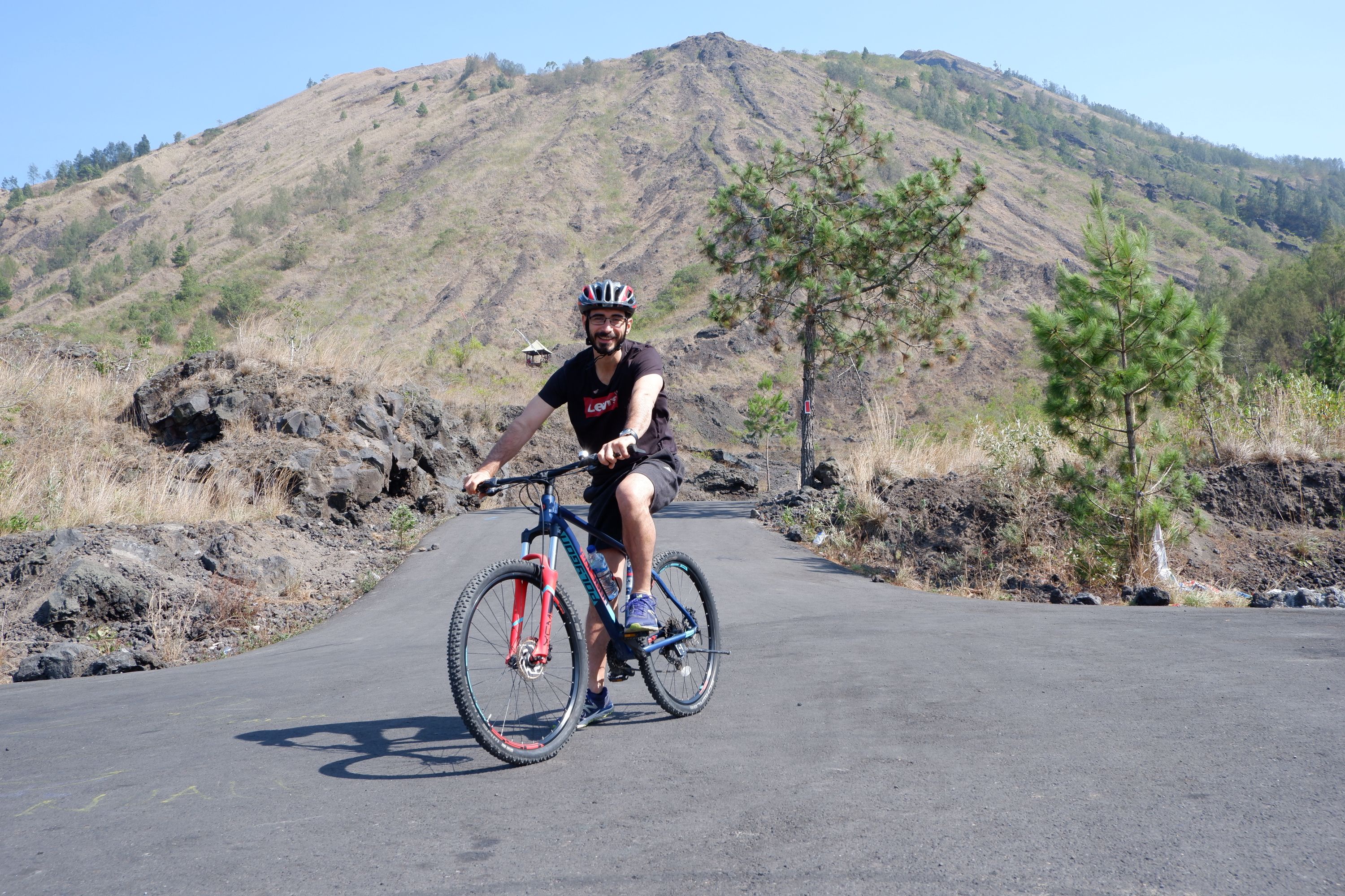 Experience the rugged landscapes of Mount Batur on a mountain bike navigating black lava fields and picturesque villages. Conclude with a soothing dip in natural hot springs overlooking the stunning lake.