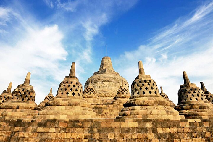 Explore the intricate beauty of Borobudur's ancient architecture while learning fascinating stories from your guide making each moment unforgettable amidst timeless stone relics.