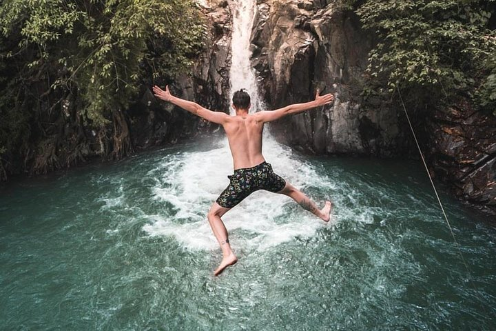 Experience the joy of diving into crystal-clear waters at Aling Aling Waterfall. Cliff jumping and slides await adventurous travelers amidst Bali's stunning natural beauty.