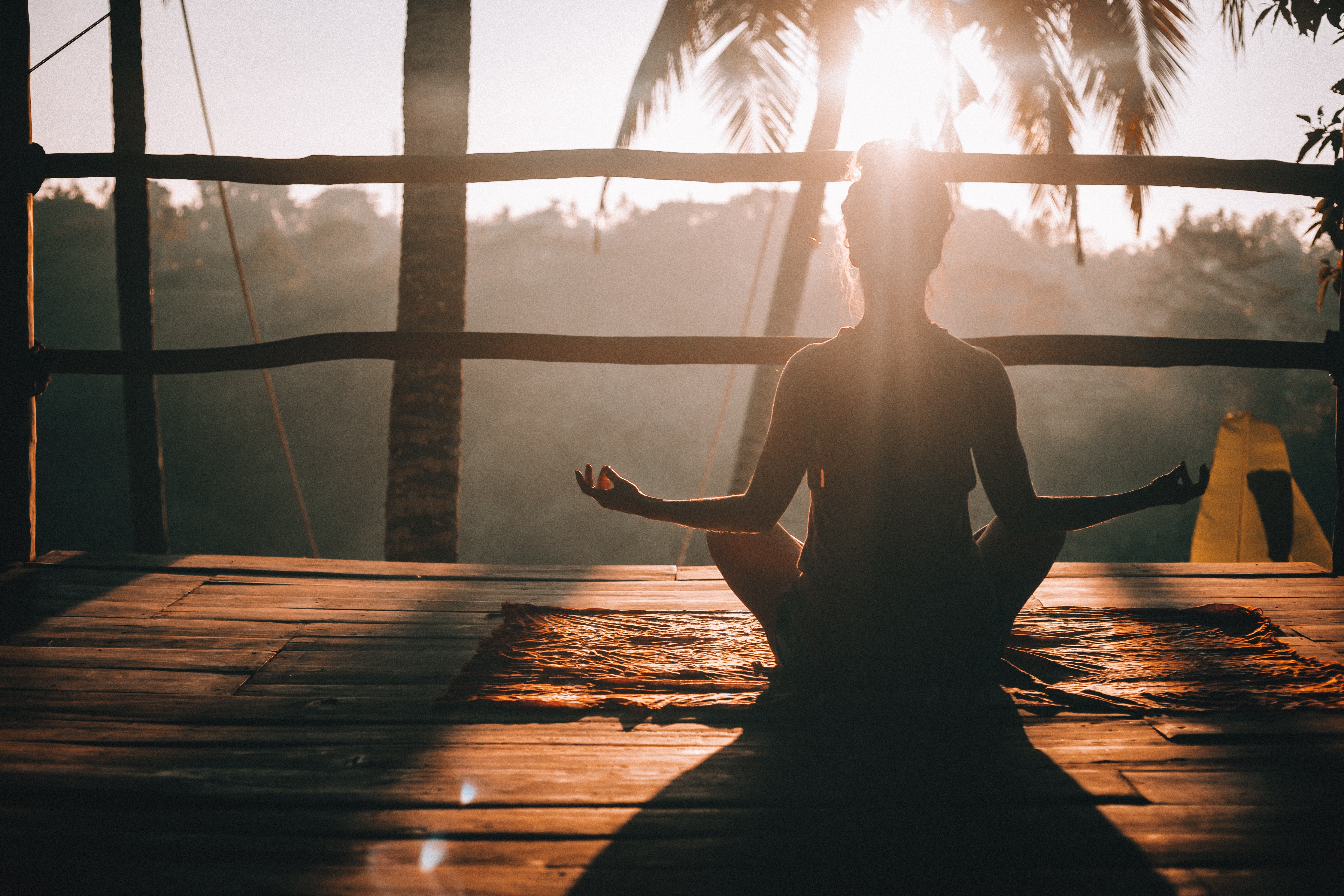 Bask in the serene glow of sunrise embracing harmony through yoga amidst Bali's lush landscapes. Each moment fosters a deep connection with nature and self-discovery.