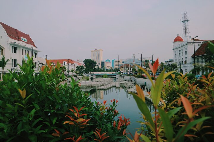 Explore Jakarta's blend of modernity and tradition as you stroll along scenic waterways vibrant greenery and charming architecture creating memorable moments throughout your private tour experience.