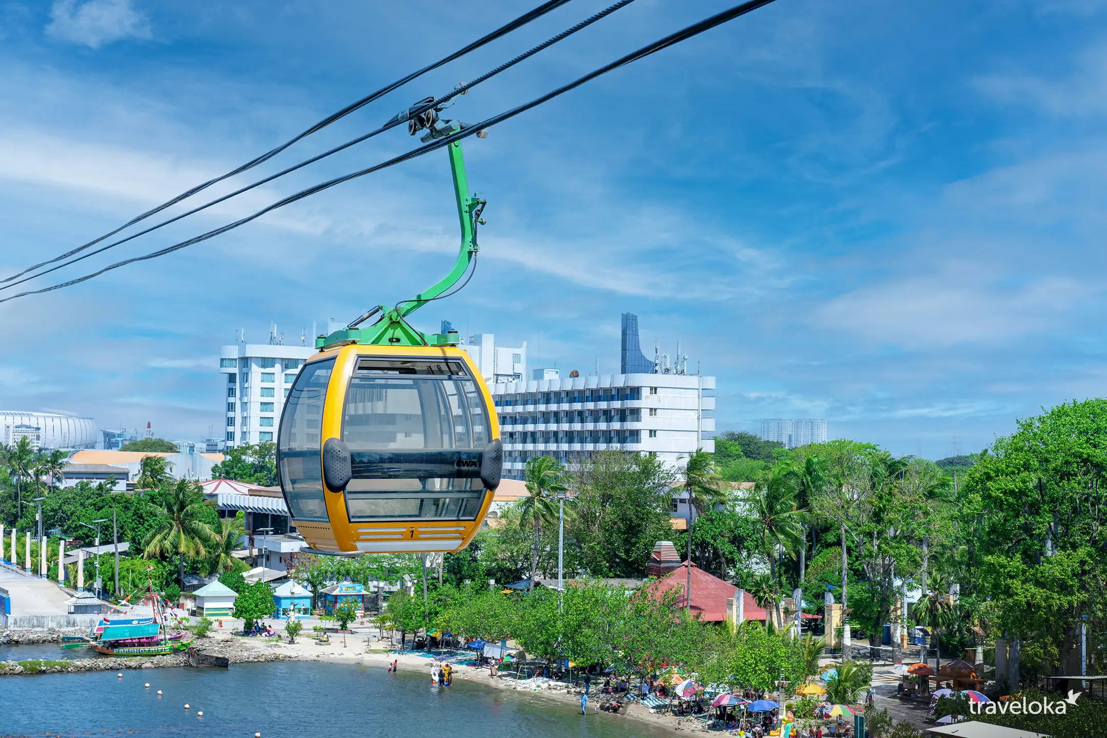 Experience stunning views of Jakarta Bay as the Gondola Ancol glides above lush scenery connecting you to nearby attractions like Dufan and SeaWorld for an unforgettable journey.