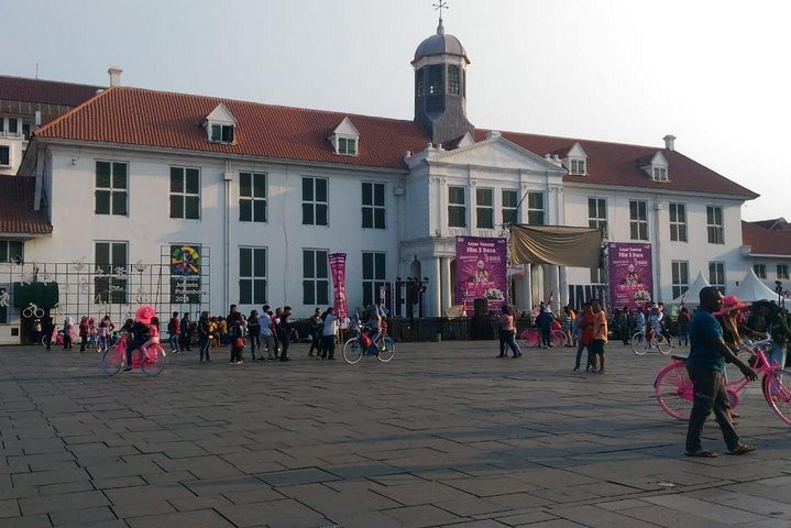 Experience Jakarta's charm as day transitions to night exploring historic sites and indulging in street food delights blending cultural discoveries with lively market scenes.