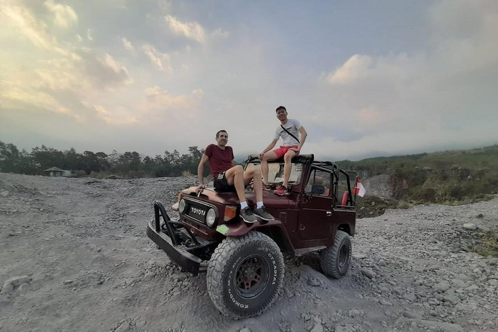 Experience the raw beauty of Merapi’s landscape as you navigate rocky terrain with friends uncovering the rich history and culture of Yogyakarta on an unforgettable jeep adventure.
