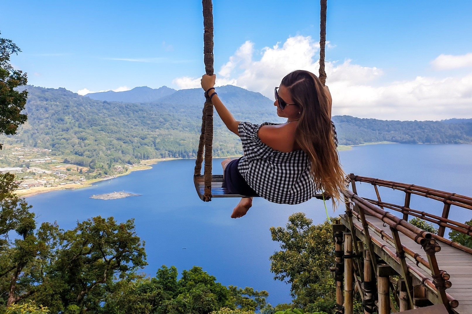 Swinging high above tranquil waters and lush landscapes this idyllic spot in North Bali invites travelers to capture unforgettable memories against a stunning backdrop. Perfect for Instagram moments!
