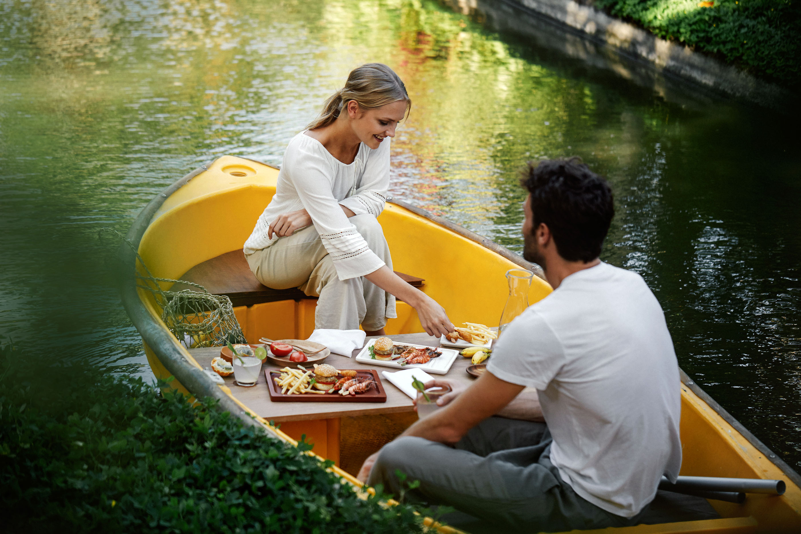 Savor delightful canapes and sparkling drinks while surrounded by tranquil waters. Connect with nature as you feed friendly koi fish creating unforgettable moments in Bali's serene setting.
