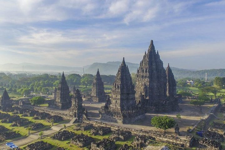 Experience the stunning beauty of Prambanan Temple at sunset while savoring Yogyakarta's traditional cuisine. Enjoy the Ramayana Ballet under a sky filled with history and culture.