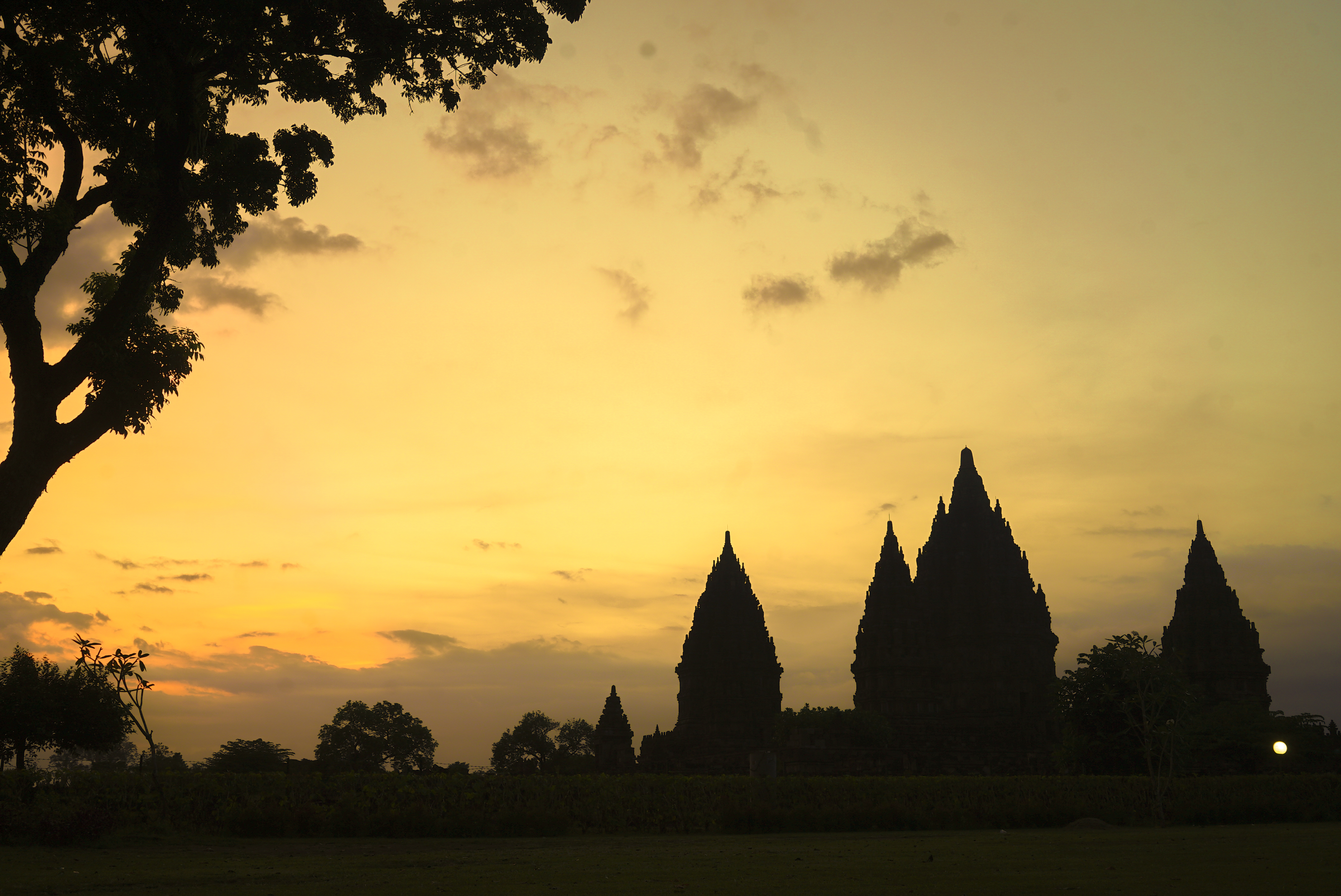 Experience the picturesque silhouette of Prambanan Temple at sunset where the iconic spires contrast beautifully against the colorful sky inviting storytelling and exploration of its rich heritage.