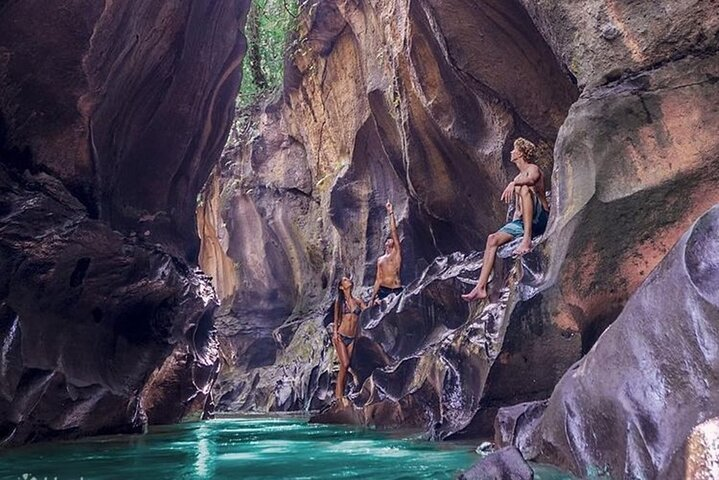 Experience the stunning rock formations and crystal-clear waters of Hidden Canyon Beji Guwang where adventurers discover hidden pools and enjoy river trekking amid lush surroundings in Bali.