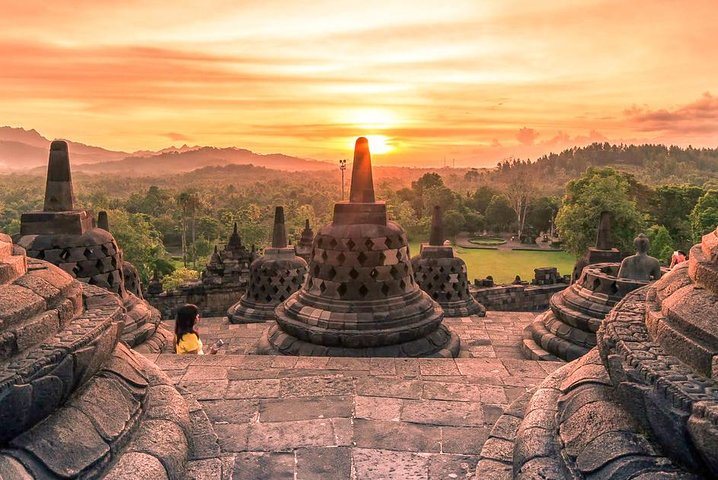 Awaken to the stunning sunrise over Borobudur where ancient temple spires meet lush landscapes inviting exploration and adventure in Yogyakarta's rich cultural heritage and natural beauty.