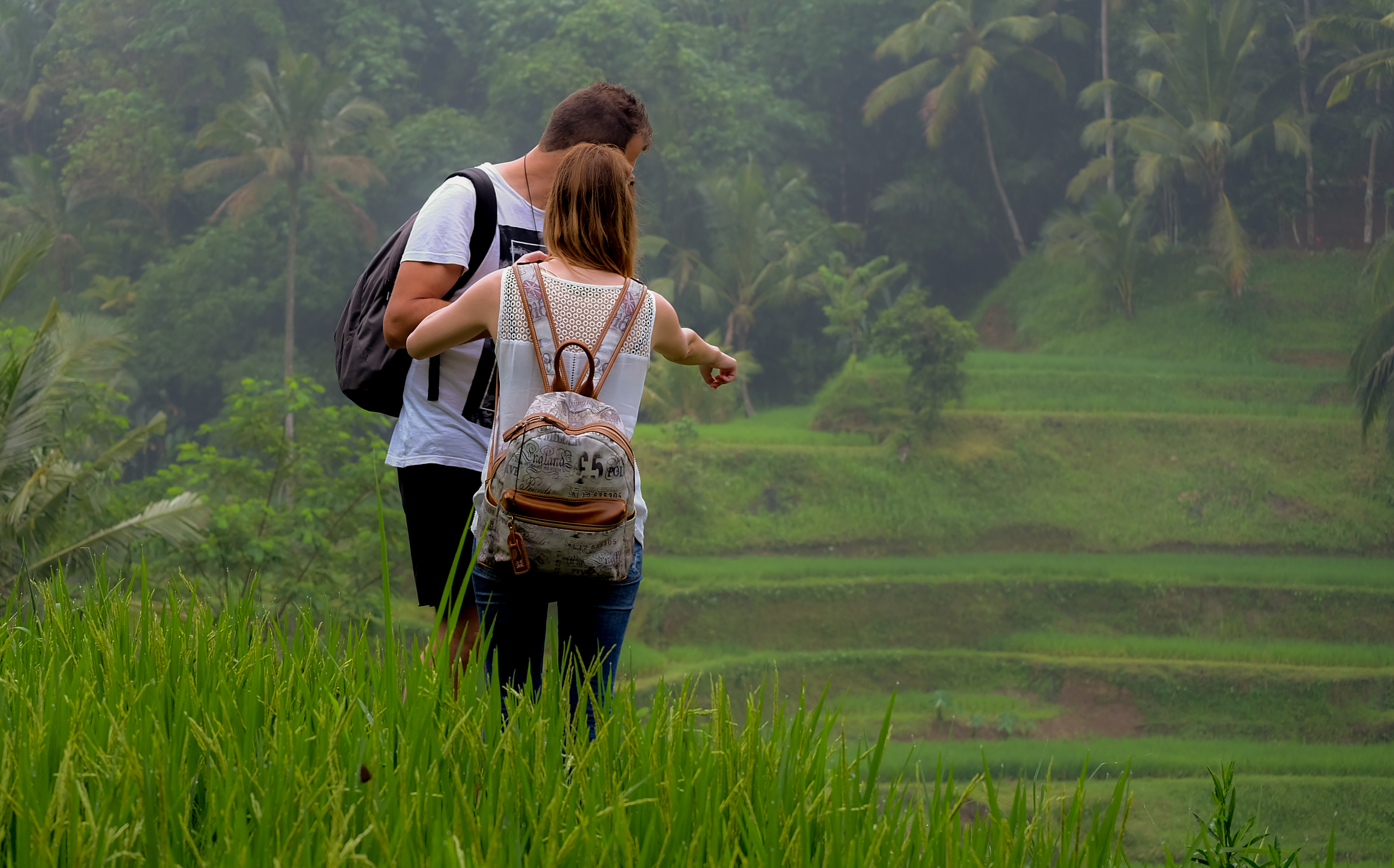 Explore the lush rice terraces of Bali with a loved one surrounded by stunning landscapes and the serenity of nature creating unforgettable moments in this idyllic setting.