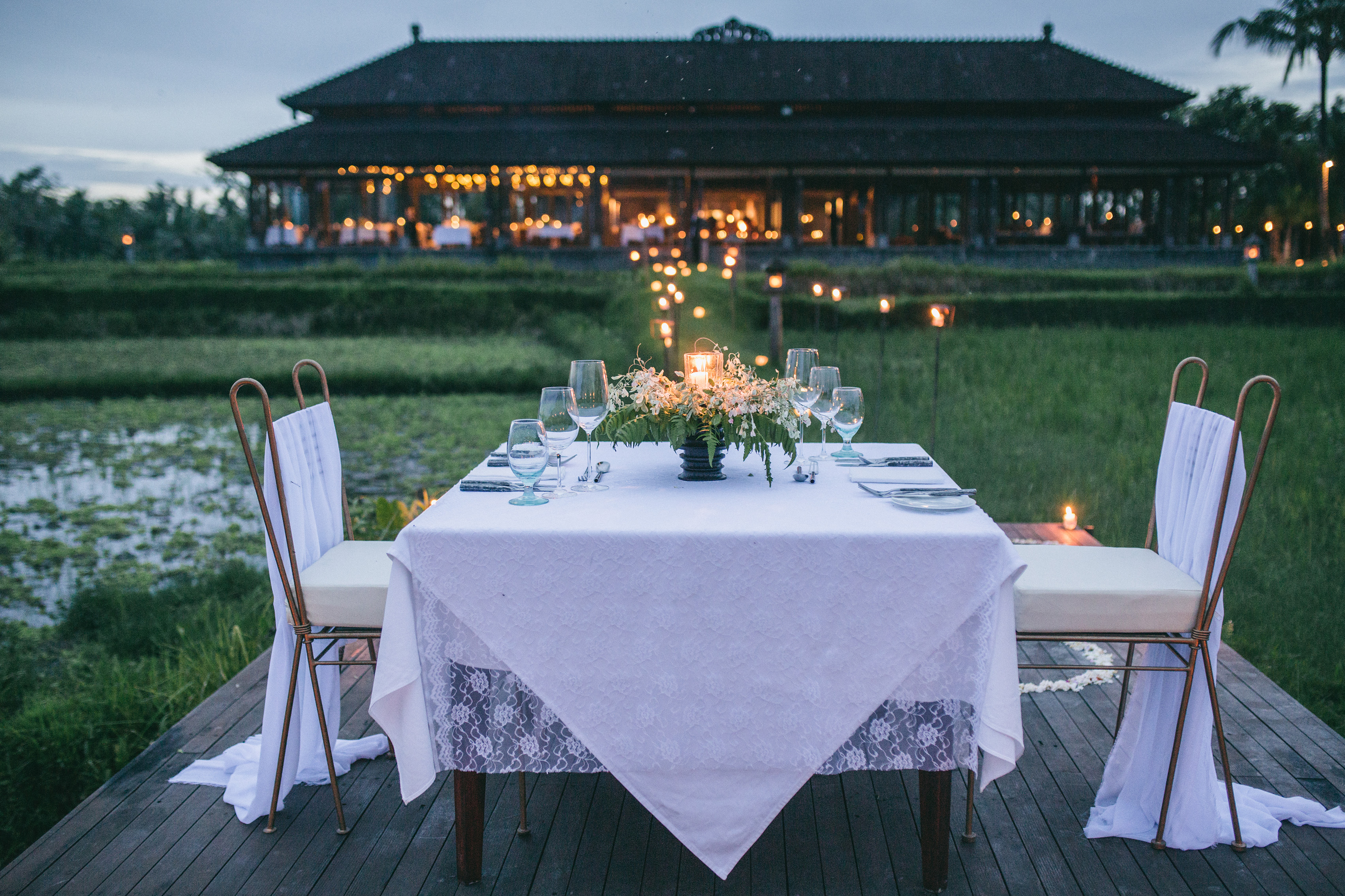 Experience a serene 5-course dinner amidst lush rice paddies in Ubud Bali. Enjoy exquisite cuisine under starlit skies creating unforgettable memories with your loved one.
