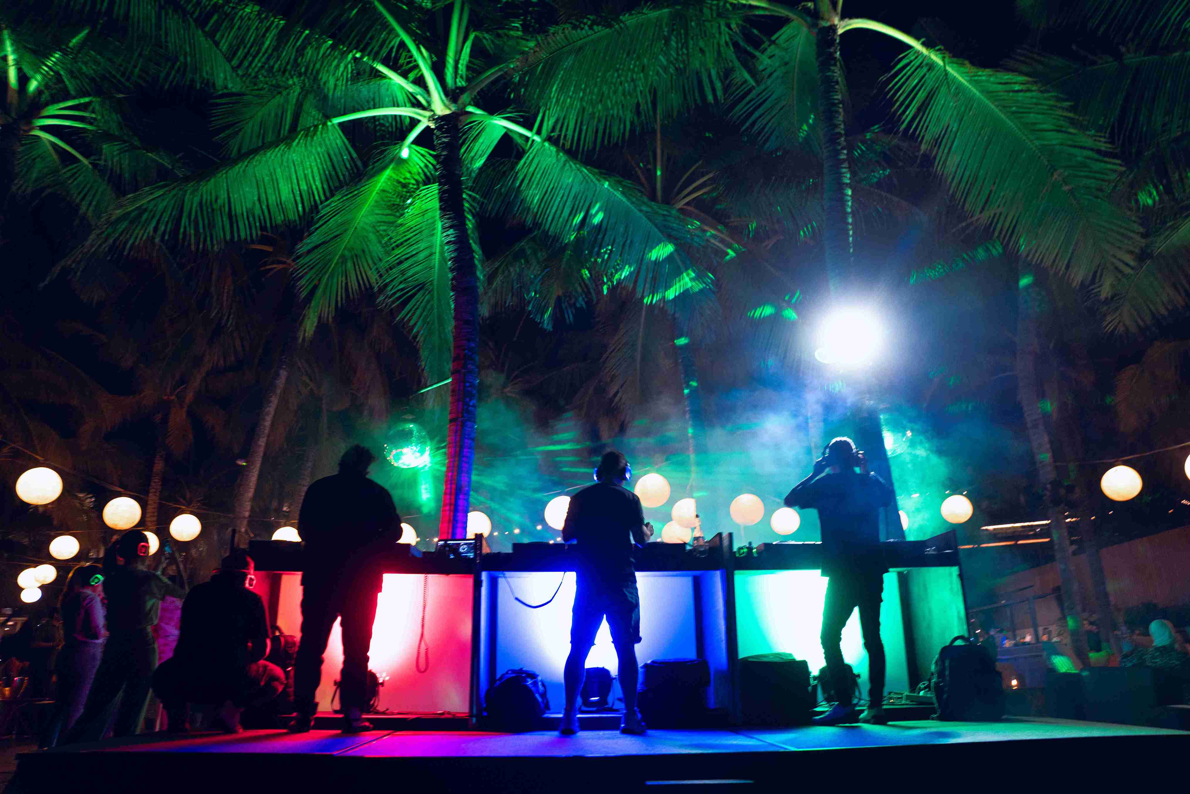 Immerse yourself in a unique dance experience under Bali’s palm trees where glowing headsets let you choose your soundtrack. Enjoy personal vibes while mingling with friends in stunning surroundings.