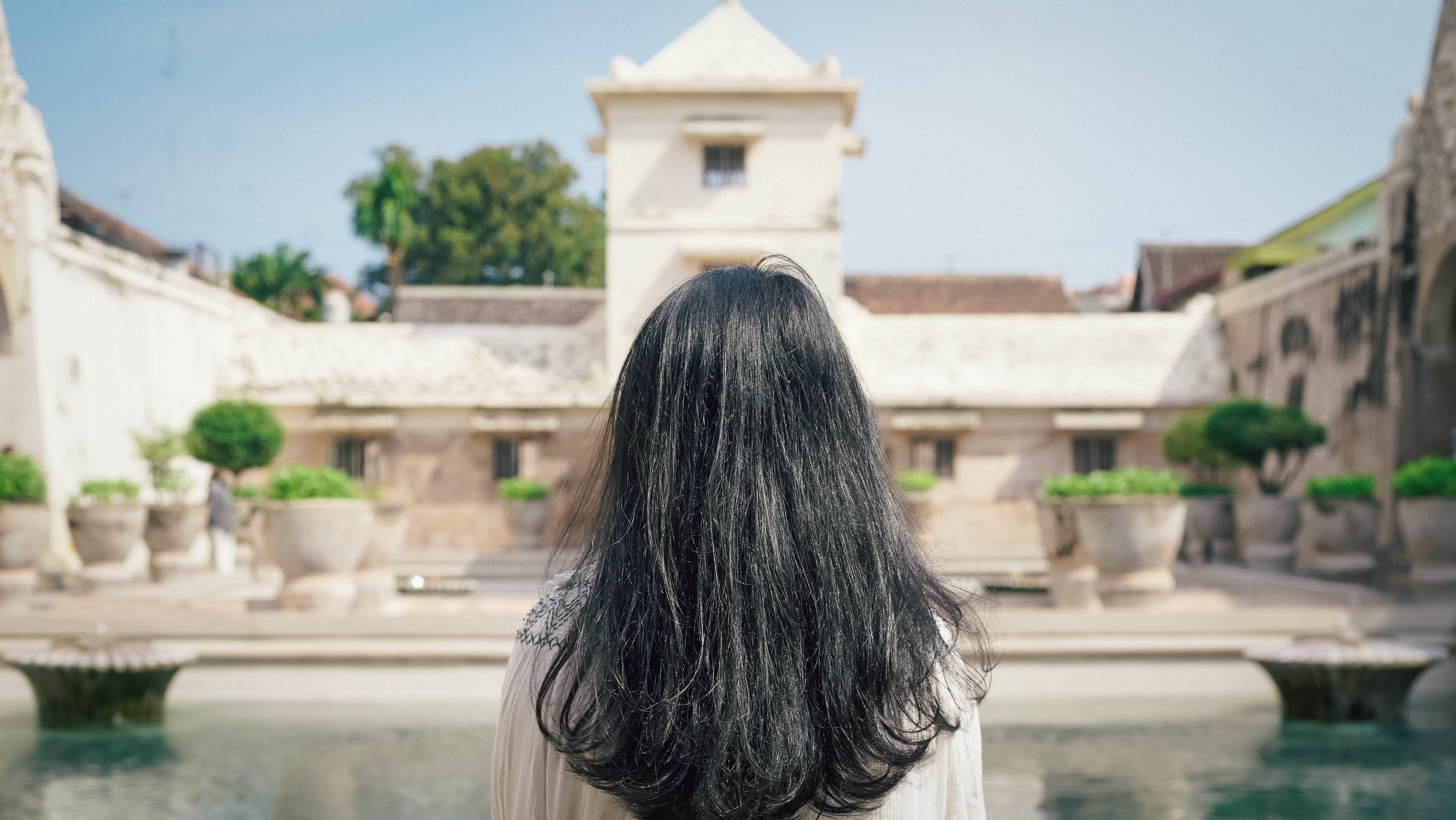 Discover the serene beauty of Taman Sari Water Castle with its pools and lush gardens offering a glimpse into royal relaxation and meditation in historic Yogyakarta.