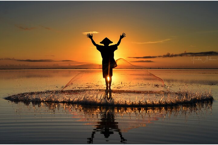 Fisherman during sunrise with the net