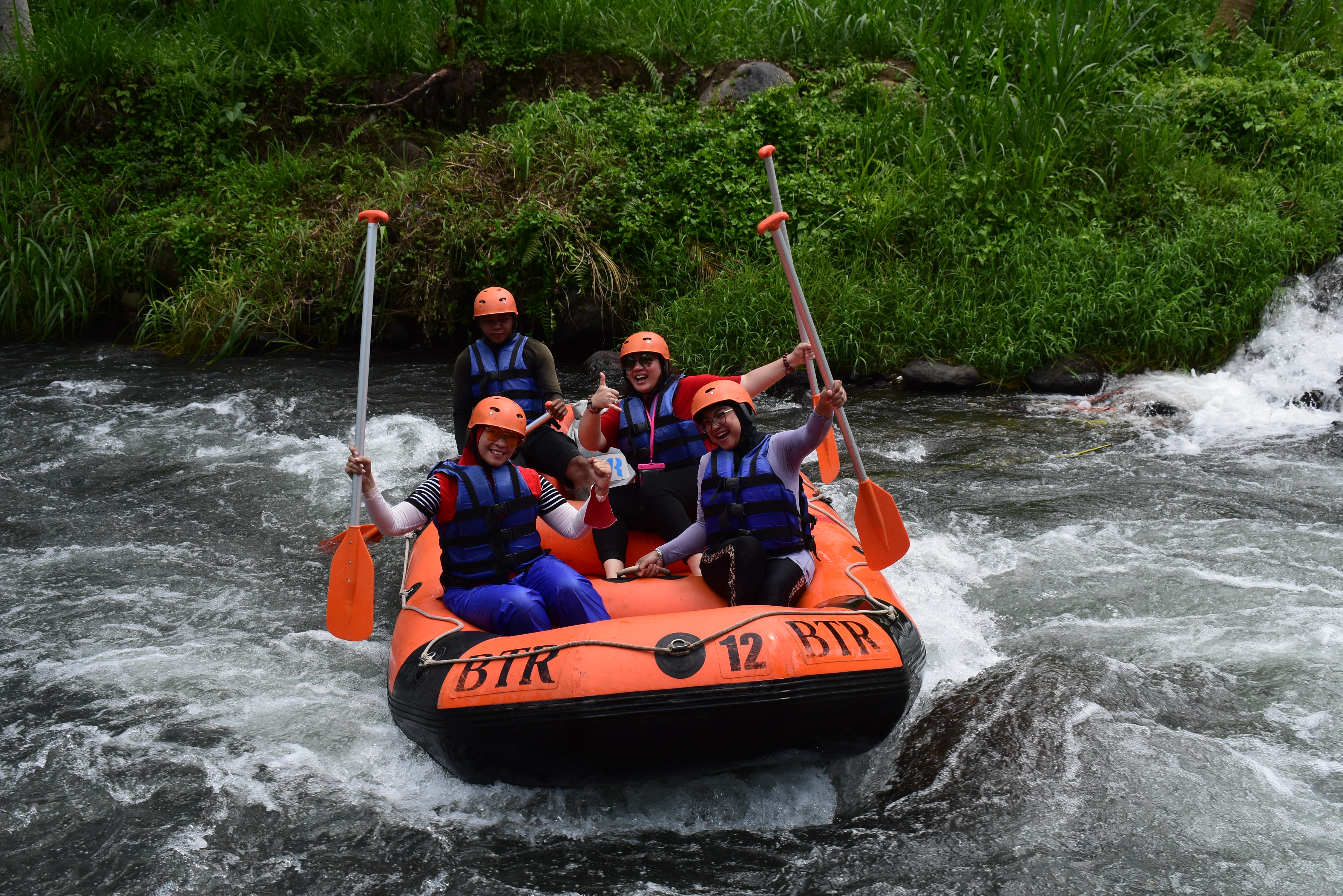 Navigate Class III+ rapids on the Telaga Waja River enjoying stunning landscapes and sharing an unforgettable adventure with friends perfect for both excitement and relaxation in Bali's natural beauty.