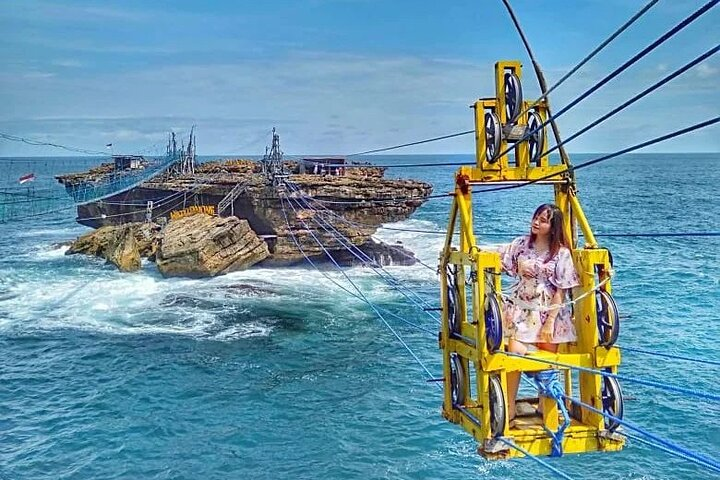 Experience the exhilaration of crossing the ocean in a traditional gondola surrounded by stunning rock formations and sparkling turquoise waters at Timang Beach. Perfect for unforgettable moments.