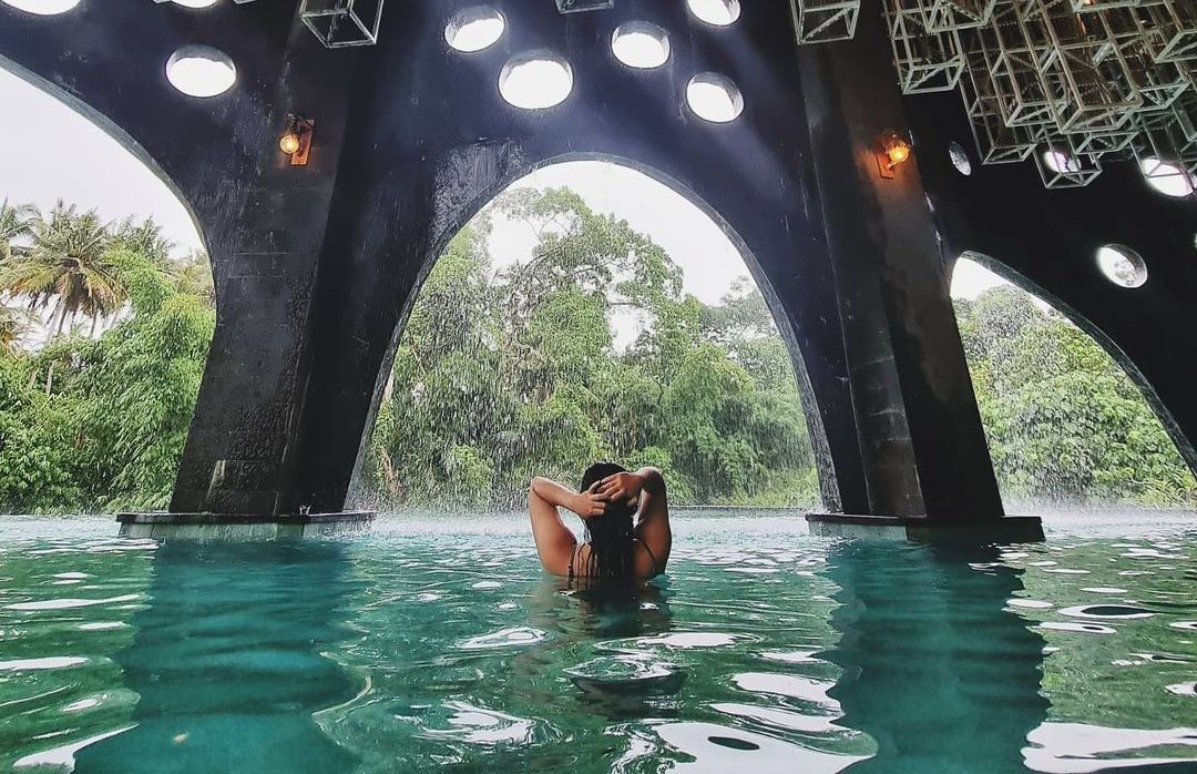 Relax in the serene beauty of Bali as you soak in the refreshing infinity pool surrounded by lush greenery creating the perfect backdrop for unforgettable moments with friends and family.