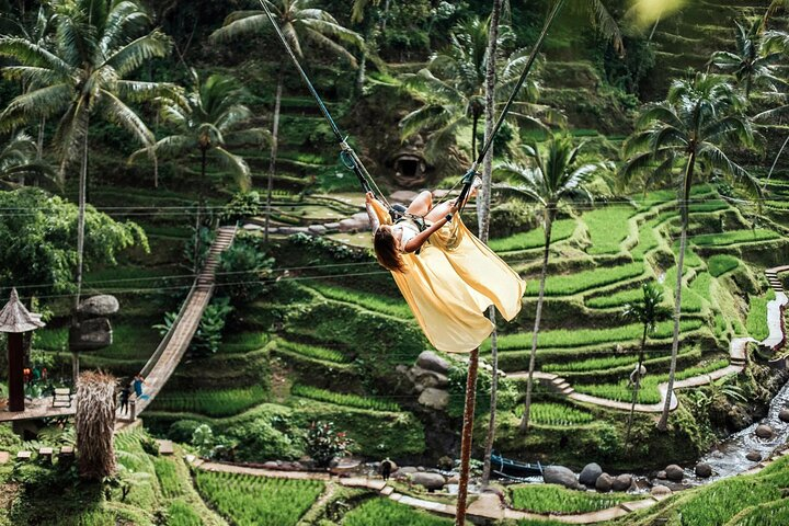 Experience the lush beauty of Ubud as you swing above breathtaking rice terraces creating unforgettable memories while surrounded by nature's finest craftsmanship and serene landscapes.