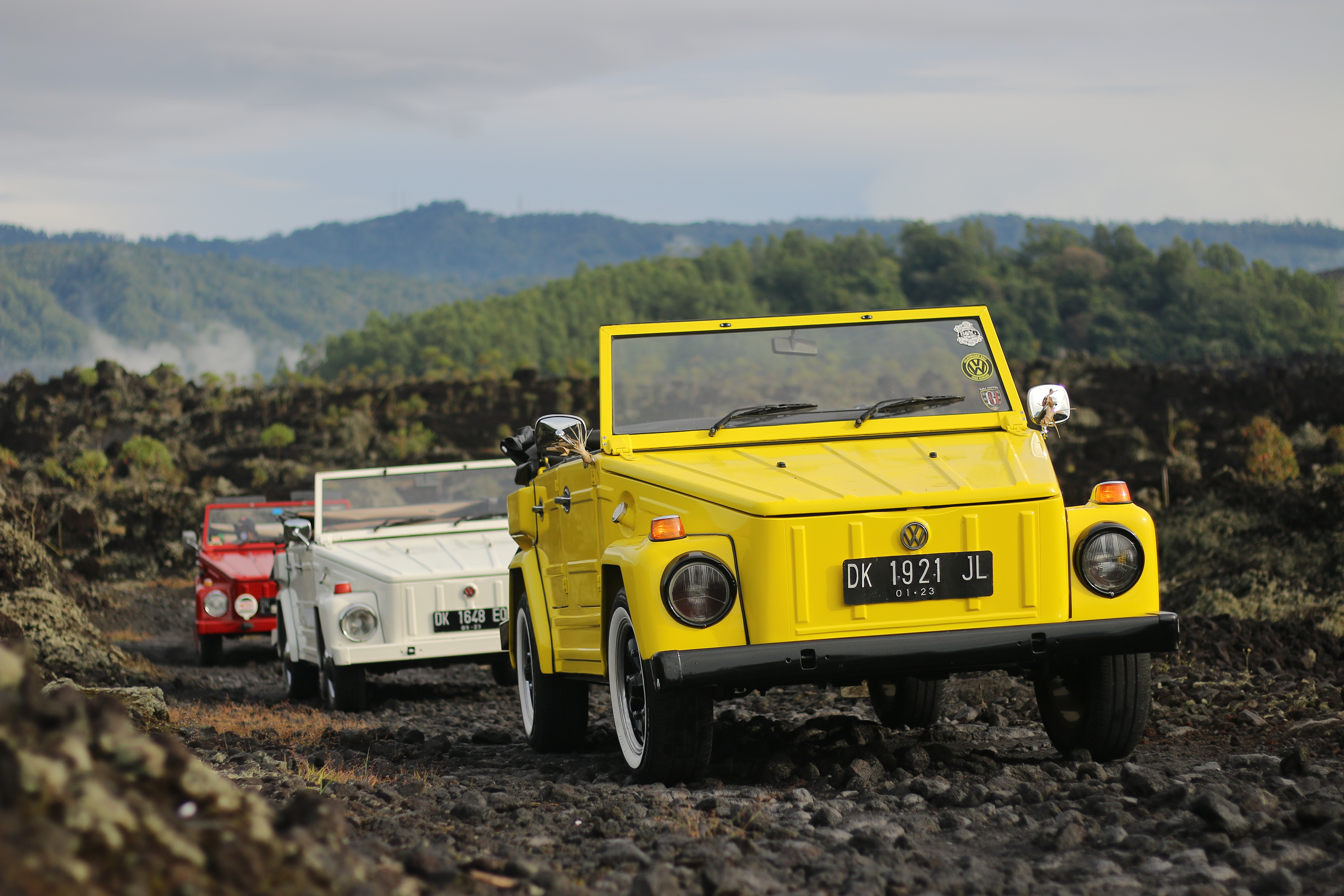 Explore Bali's stunning landscapes in a classic Volkswagen jeep navigating through volcanic terrain rice terraces and lush vegetation while discovering the rich history of Mount Batur.